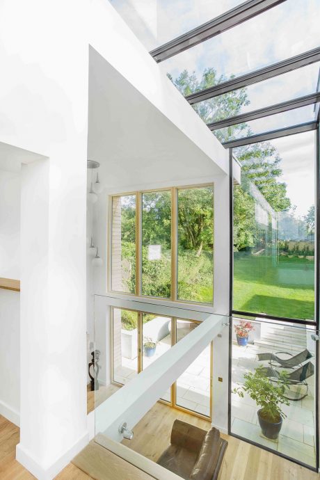 Bright and airy interior with expansive windows overlooking a lush green landscape.