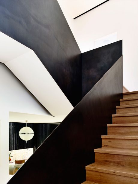Dramatic black-and-white architectural elements, including a striking staircase and geometric shapes.