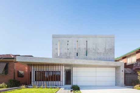 Modern, minimalist architectural design featuring concrete, wood, and glass elements.