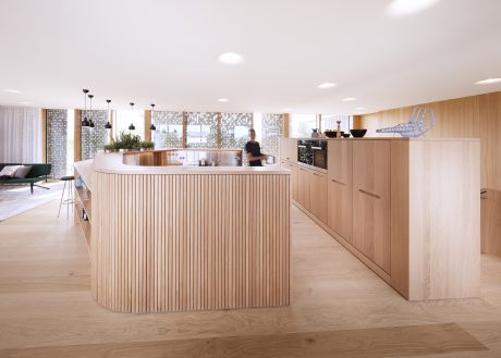 A modern, open-concept kitchen featuring a curved wood island and backsplash with minimalist lighting.