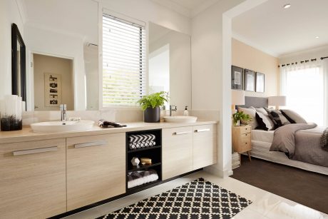 Spacious modern bathroom with large vanity, shelving, and view to adjacent bedroom.