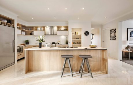 Bright, open kitchen with sleek wooden cabinetry, modern appliances, and stylish bar stools.