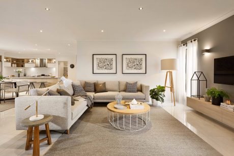 Stylish open-concept living area with neutral color palette, modern furnishings, and artwork.