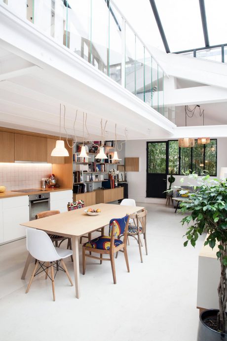 Bright, open-concept living space with wooden accents, glass walls, and sleek furnishings.