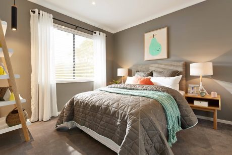 Cozy and inviting bedroom featuring warm gray walls, textured headboard, and pops of color.