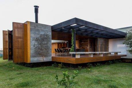 Striking outdoor entertainment area with modern concrete, wood, and metal design elements.