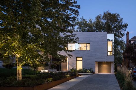 Contemporary two-story residence with sleek, modern design and strategic lighting.