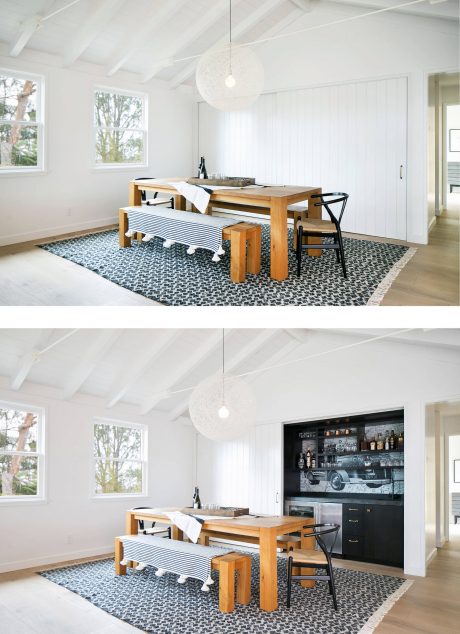 Bright, minimalist dining space with wooden table, patterned rug, and black built-in bar.