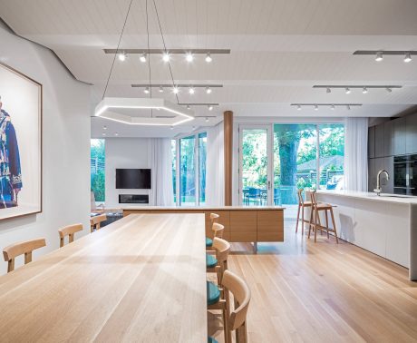 Spacious open-concept kitchen and dining area with modern lighting, wood accents.