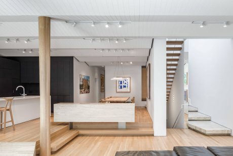 A spacious, modern interior with clean lines, neutral colors, and a mix of wood and stone elements.
