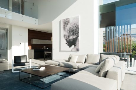Bright, modern living room with clean lines, neutral palette, and abstract artwork.