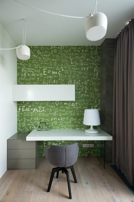 A science-themed workspace with chalkboard-style wall, modern desk, and minimalist lighting.