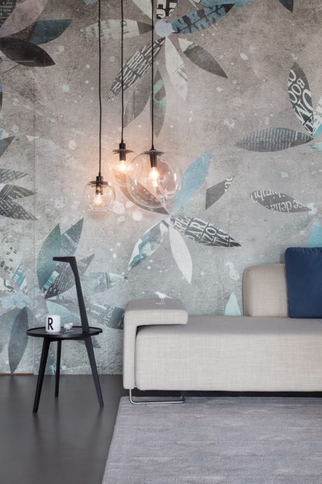 Modern living room with abstract wallpaper, pendant lights, and minimalist furniture.
