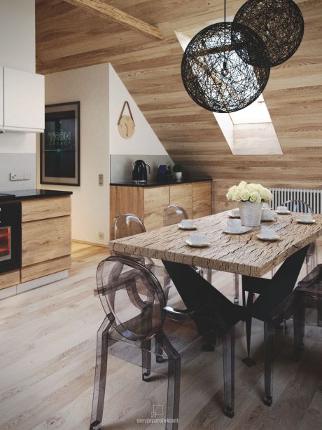 Rustic wooden walls and ceiling, black pendant lamps, and a sturdy wooden dining table with transparent chairs.