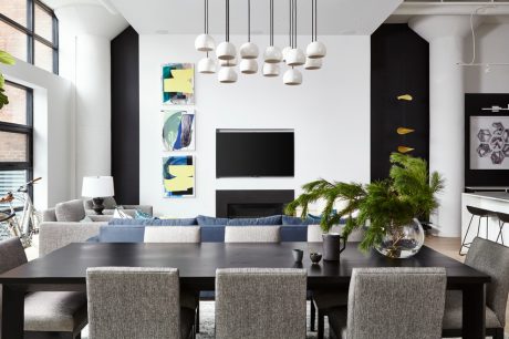 Sleek, modern living space with stylish lighting, artwork, and minimalist furniture.