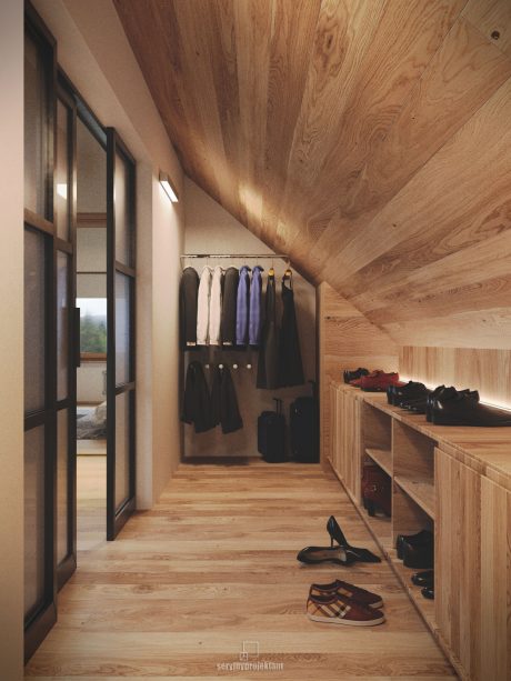 Rustic wooden hallway with built-in storage and clothing racks, cozy and inviting.