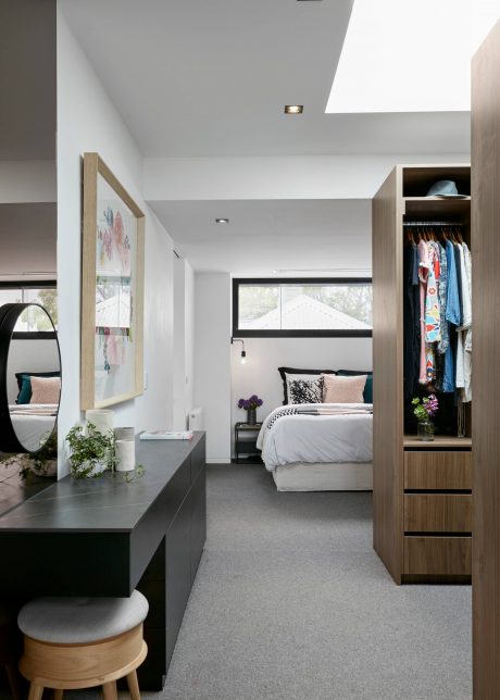 Elegant and modern bedroom design with minimalist furniture, warm lighting, and ample storage.
