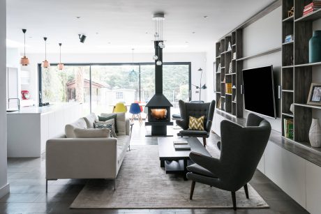 Cozy living room with contemporary furniture, fireplace, and built-in shelving.