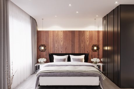 Luxurious bedroom with warm wooden accents, modern lighting, and sleek black cabinetry.