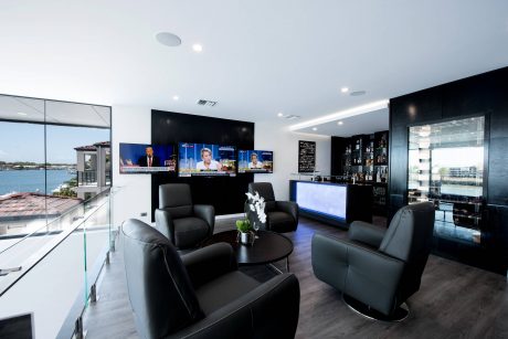 Sleek, modern lounge with floor-to-ceiling windows, plush seating, and a stylish bar.