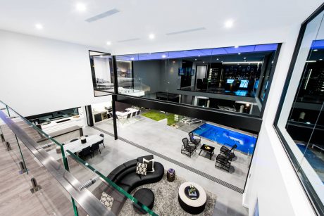 Stunning modern architectural design featuring a sleek, open-concept interior with a glass-walled pool.