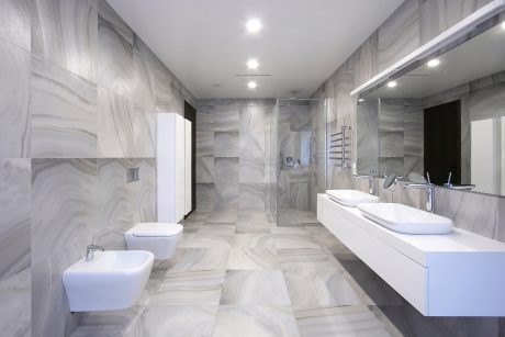 Sleek, modern bathroom with grey marble-patterned tiles, minimalist fixtures, and spacious layout.