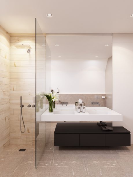 A modern bathroom with white tile, a large vanity, and black cabinetry. Sleek, minimalist design.