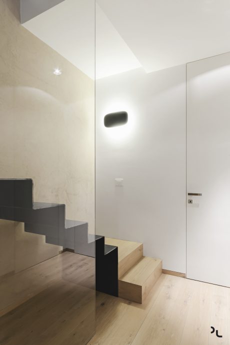 Minimalist interior design with sleek modern staircase, lighting, and clean walls.