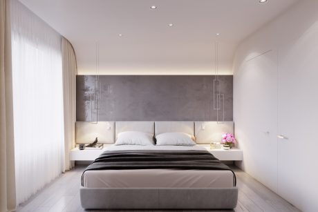 Sleek, minimalist bedroom with a large, low-profile bed and accent lighting.