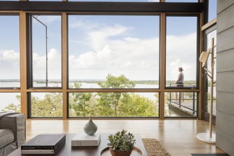 Bright, modern room with expansive windows overlooking a lush, natural landscape.