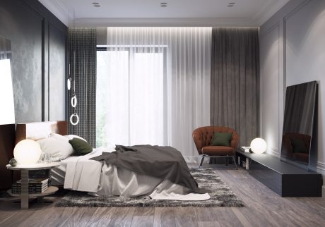 A luxurious modern bedroom with sleek gray palette, plush textiles, and warm accent chair.
