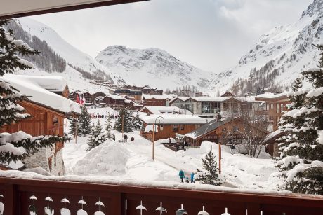 Charming alpine village with cozy wooden chalets nestled among snow-capped peaks.