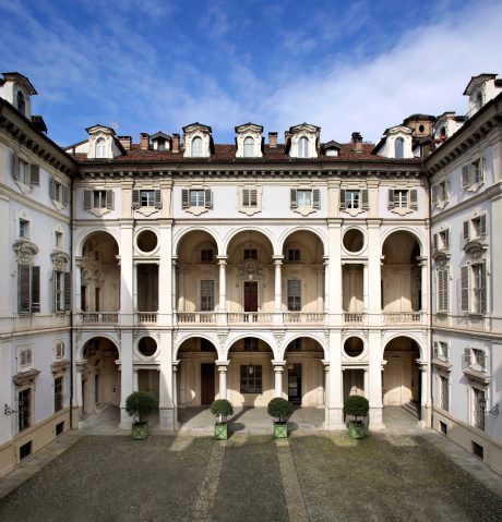 An ornate, elegant Italianate-style palace with arched windows, balconies, and a tiled roof.
