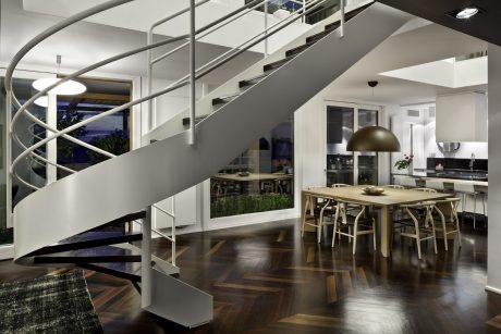 Modern, open-concept home with spiral staircase, wooden floors, and dining area.