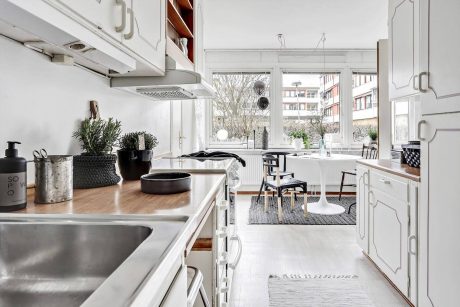 Modern, bright kitchen with sleek cabinets, large windows, and integrated appliances.