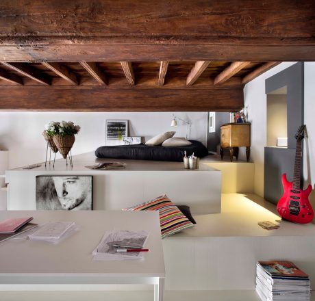 The image showcases a rustic, wooden ceiling with exposed beams and a contemporary, minimalist interior design.
