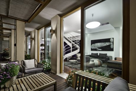 A cozy outdoor seating area with modern architectural features and stylish furnishings.