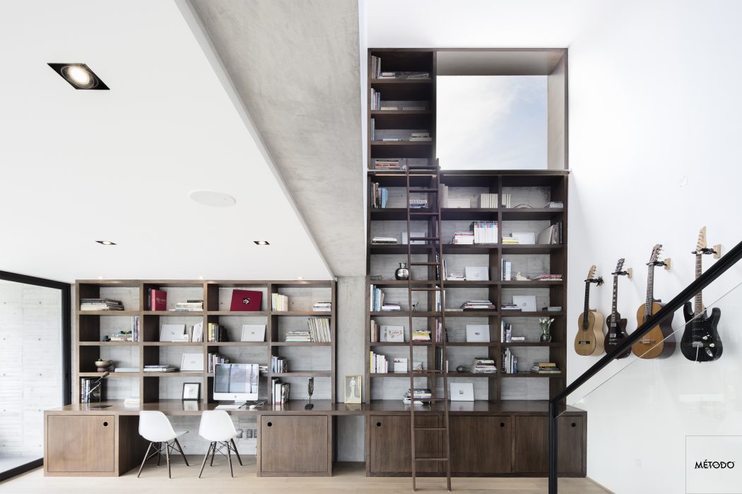 Minimalist yet functional home office with built-in shelving and storage units.
