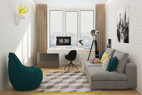 Bright, modern room with large windows, minimalist desk, gray sofa, and patterned rug.