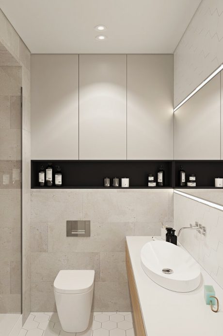 Minimalist bathroom design with recessed lighting, floating vanity, and built-in storage.