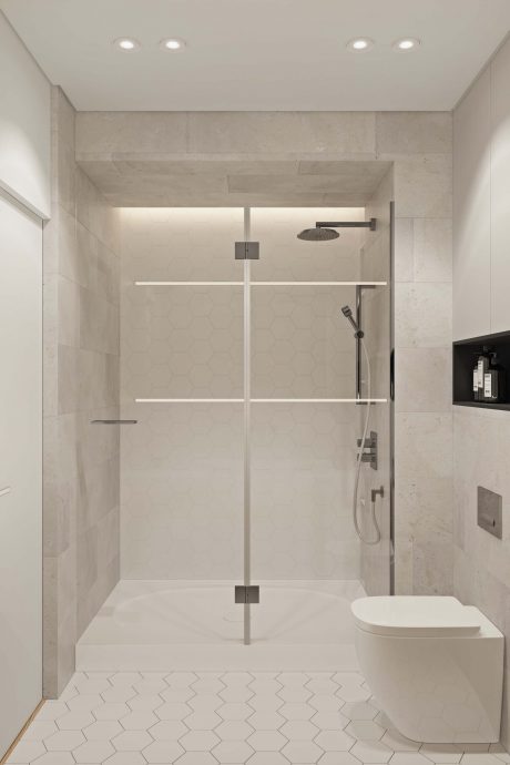 Minimalist bathroom with large glass shower enclosure, hexagonal tile floor, and recessed lighting.