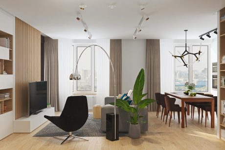 A spacious modern living room with floor-to-ceiling windows, wooden accents, and a striking chandelier.