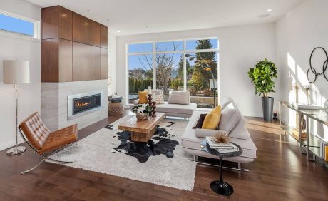 Spacious living room with contemporary fireplace, built-in storage, and large windows.
