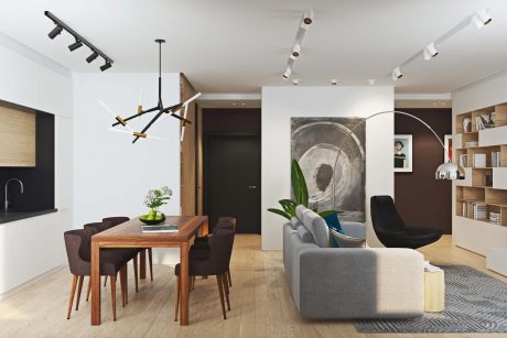 Elegant modern living space with striking light fixtures, wood furniture, and abstract art.