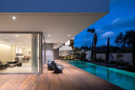 Modern residence with minimalist architectural design, elegant pool, and luxurious outdoor living space.