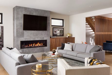 Cozy living space with modern fireplace, wood accents, and sleek furnishings.