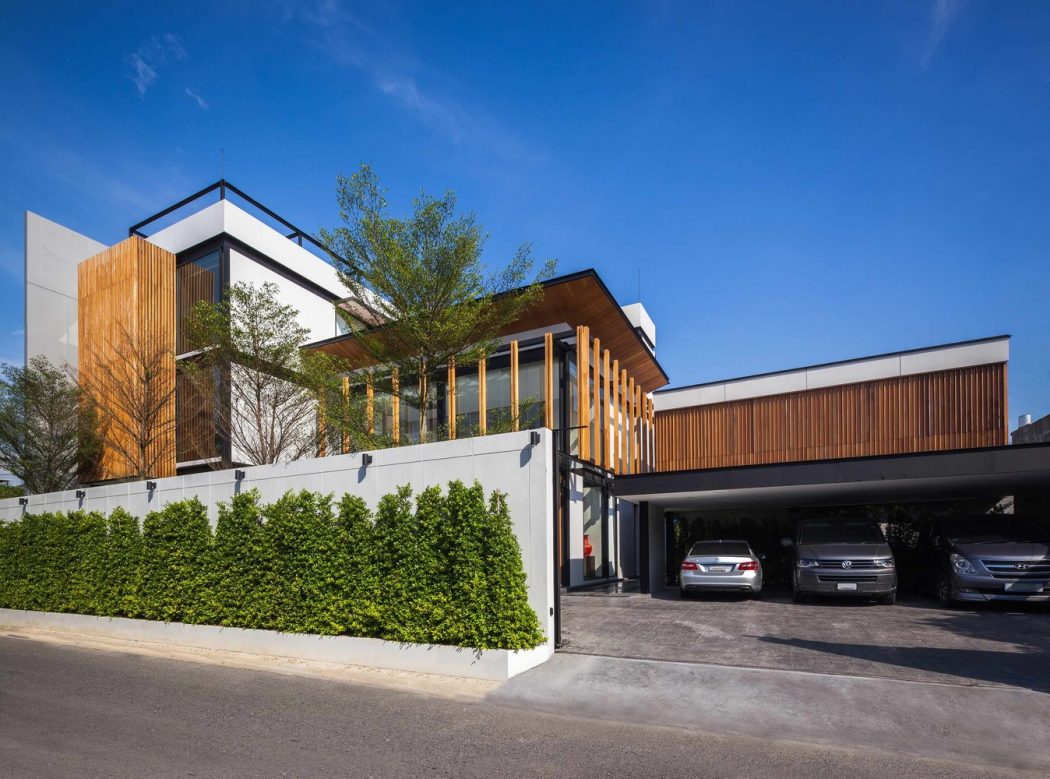 A modern, multi-story building featuring a mix of wood, glass, and concrete elements.