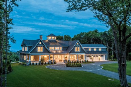 Captivating exterior of a stately, multi-gabled home with intricate woodwork and inviting porch.