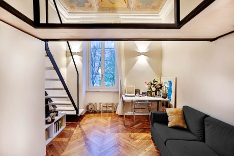 Ornate arched ceiling, hardwood flooring, modern furniture, and decorative accents.
