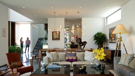Airy, minimalist living room with midcentury modern furnishings and lighting fixtures.